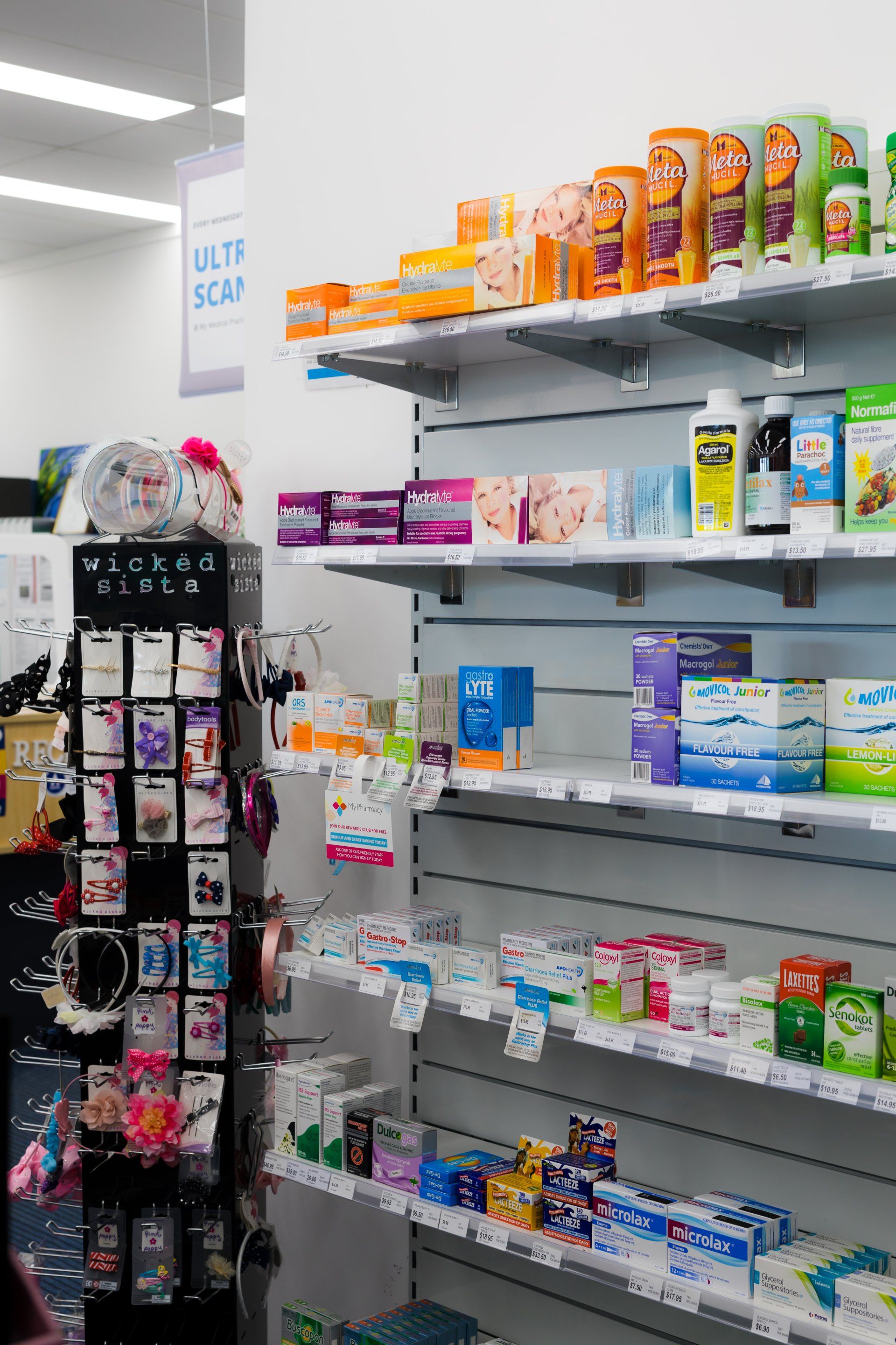 Store aisle with shelves of colorful packaged health and beauty products, including lotions and toiletries.