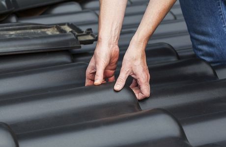 high quality roofing restoration man changing black roof