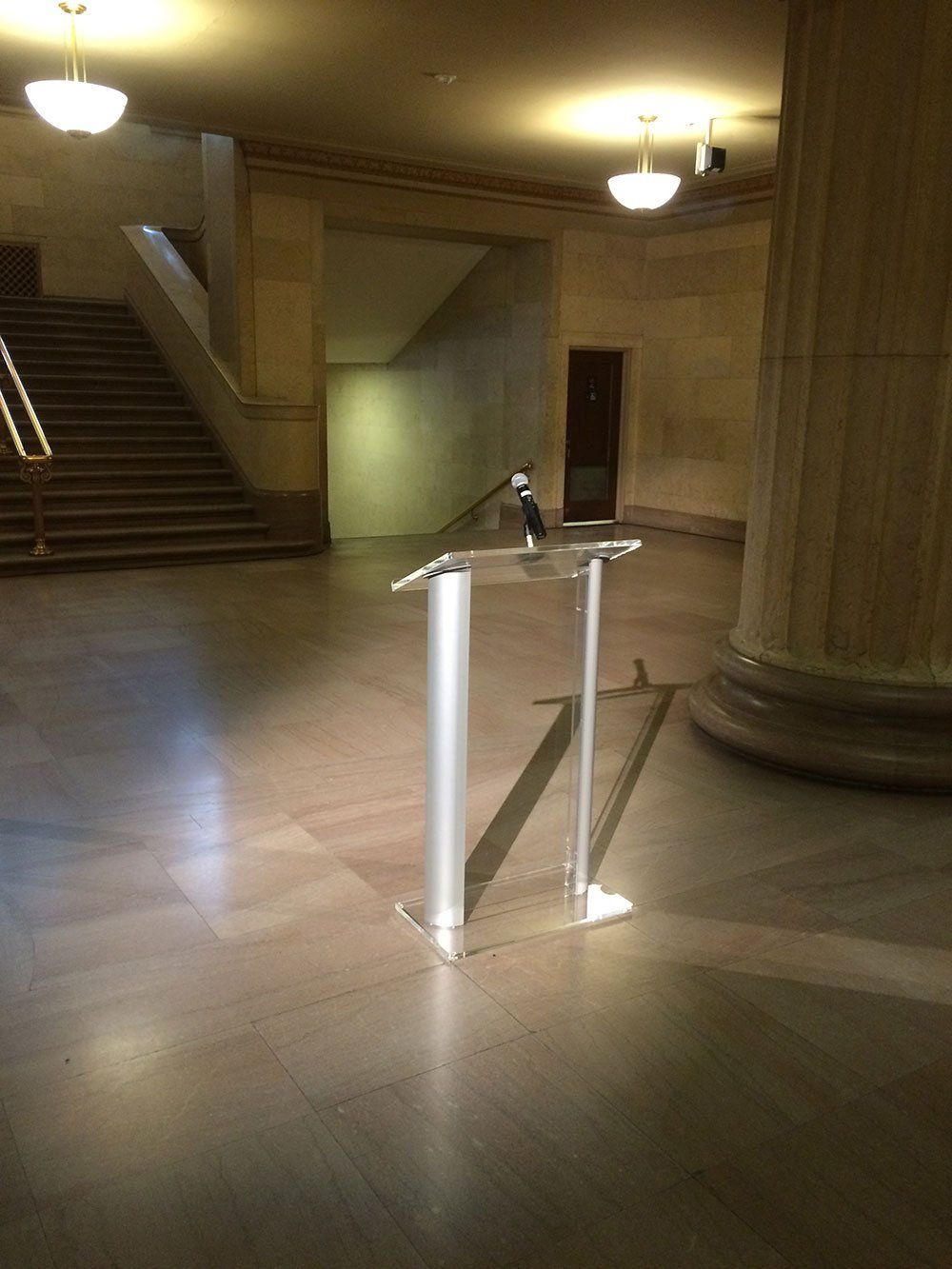 a podium with a microphone on it in an empty hallway