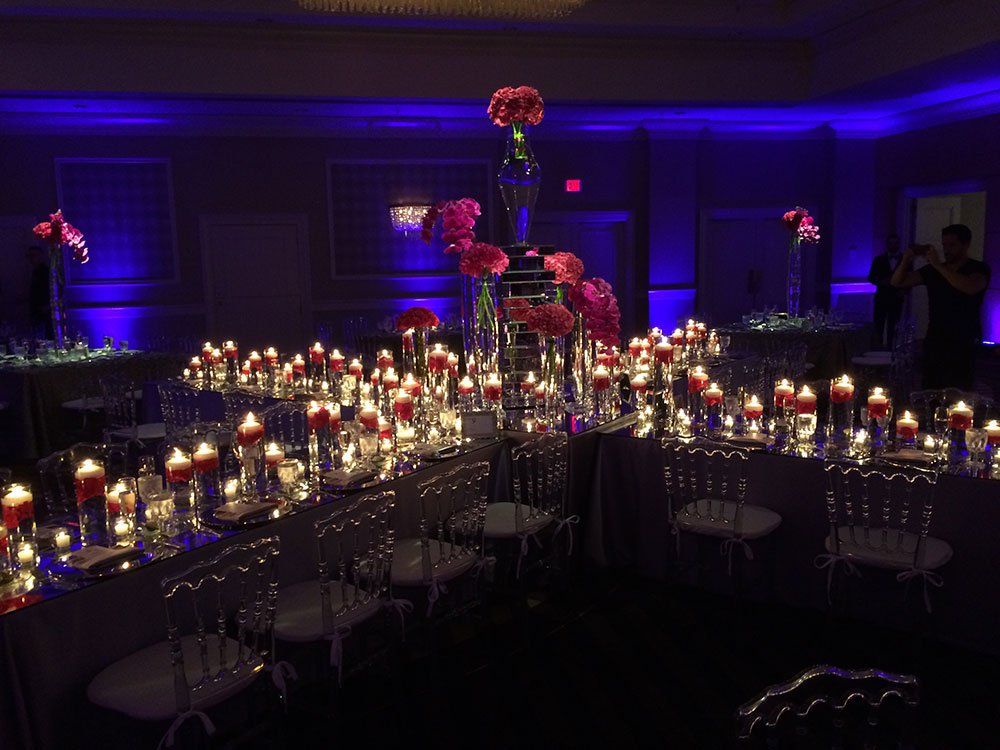 a table with a lot of candles and flowers on it