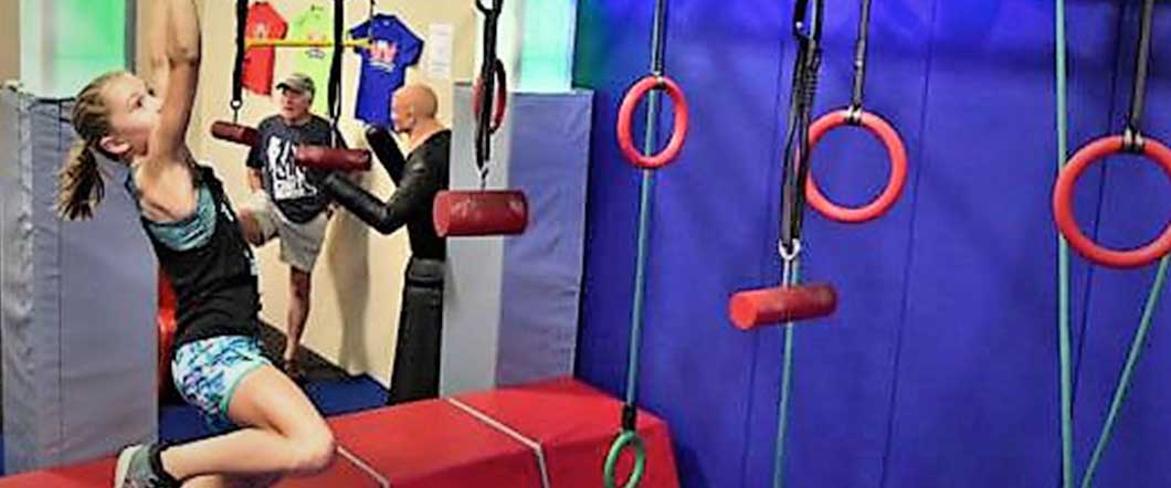 A girl having fun doing Ninja Warrior Course