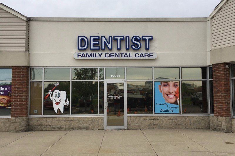 Dentist family dental care storefront with glass windows and dental posters