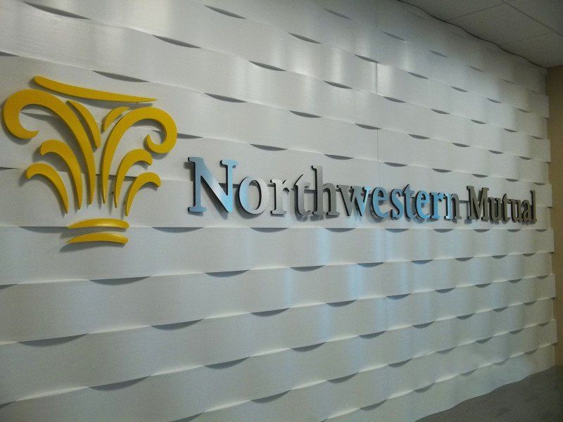 Northwestern Mutual logo on a silver textured wall in an office lobby