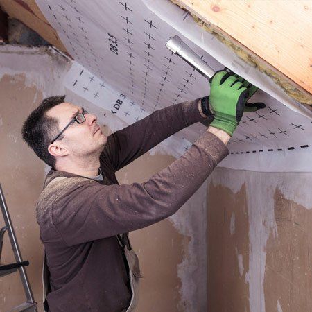 Roof insulation, worker fixing sarking membrane