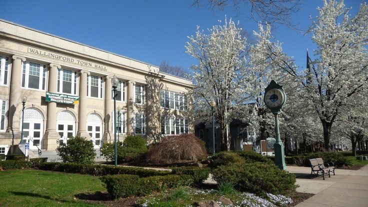 A large building with a clock in front of it
