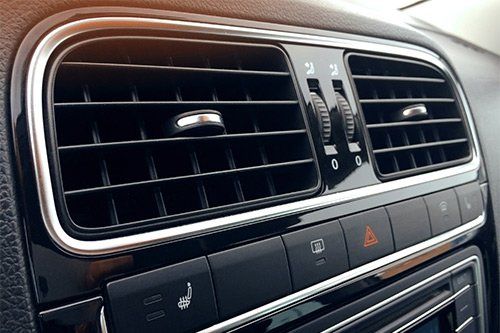 A close up of the air vents in a car.