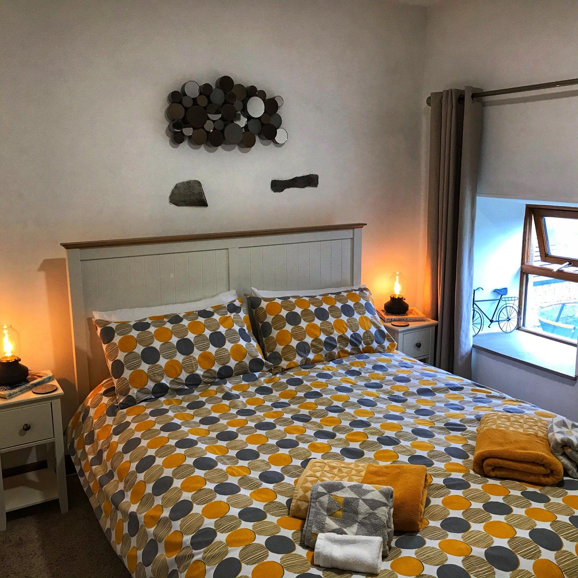 Comfy double bed with grey and mustard duvet