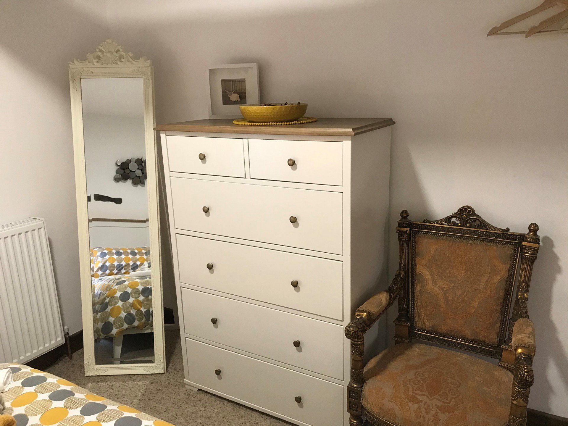 White dresser with matching mirror and antique gold chair