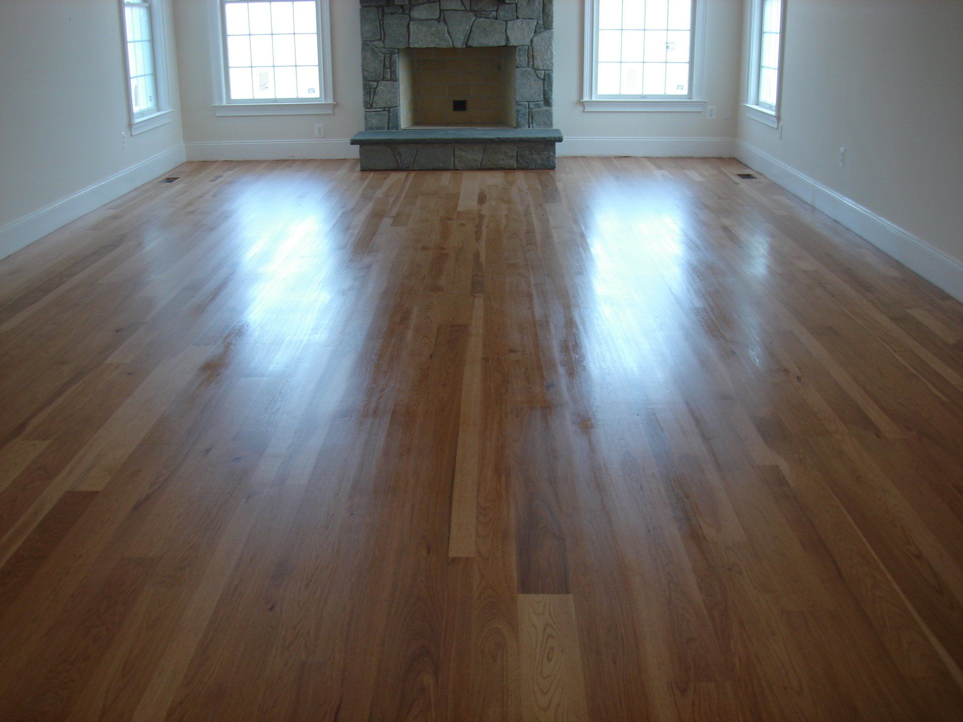 A living room with hardwood floors and a fireplace