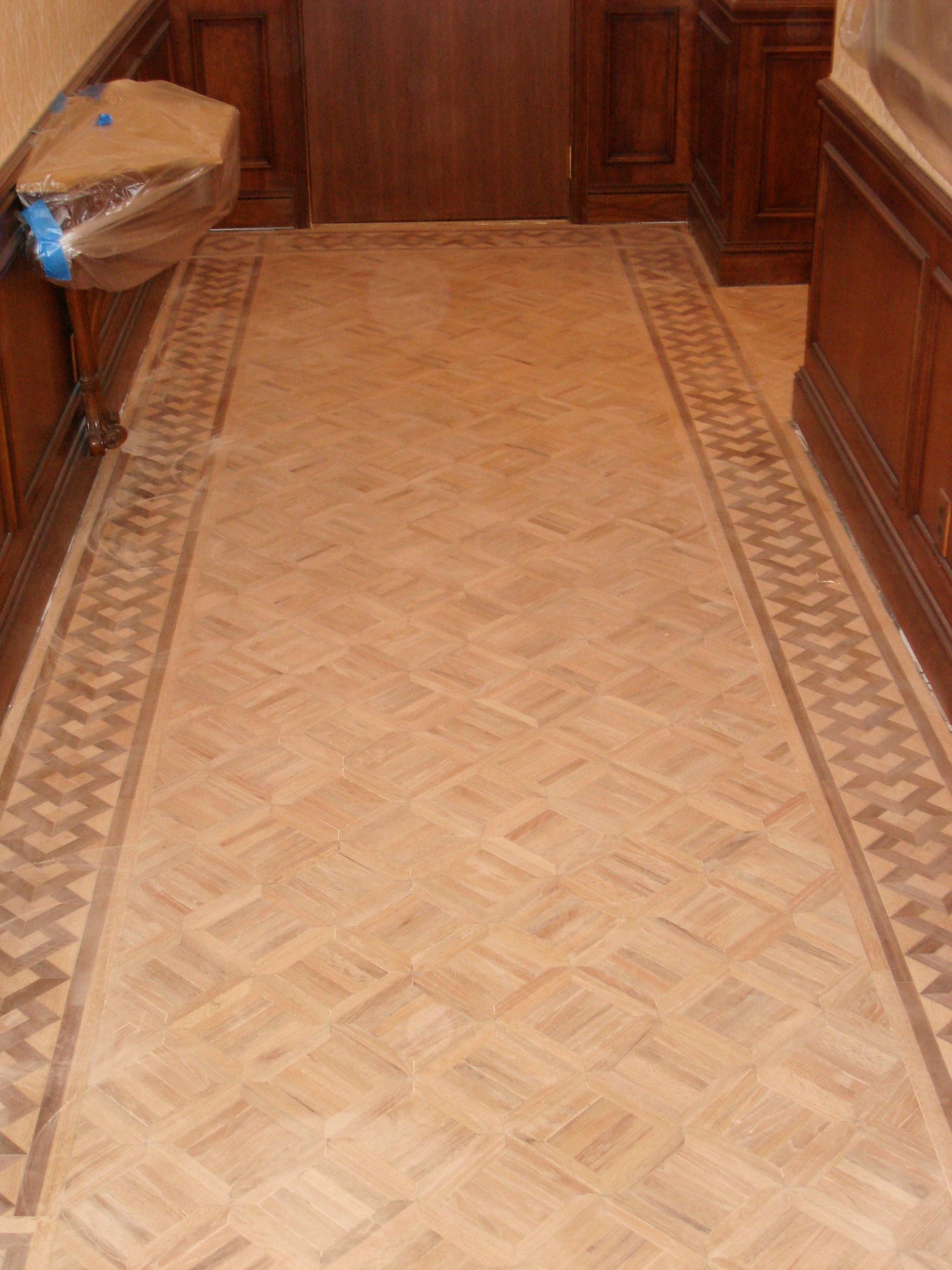 A hallway with a herringbone pattern on the floor