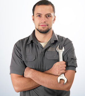 A man with his arms crossed is holding a wrench