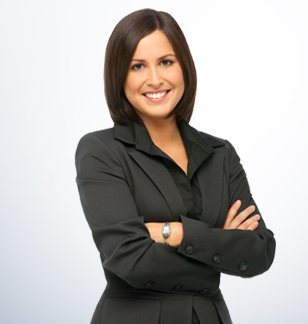 A woman in a black suit with her arms crossed