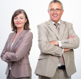 A man and a woman standing next to each other with their arms crossed