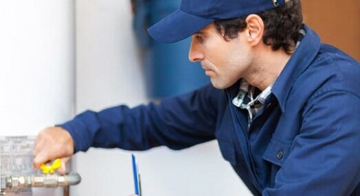 Plumber Repairing Heater — Plumbing and Heating Service in Stamford, CT Plumber Repairing Heater — Plumbing and Heating Service in Stamford, CT