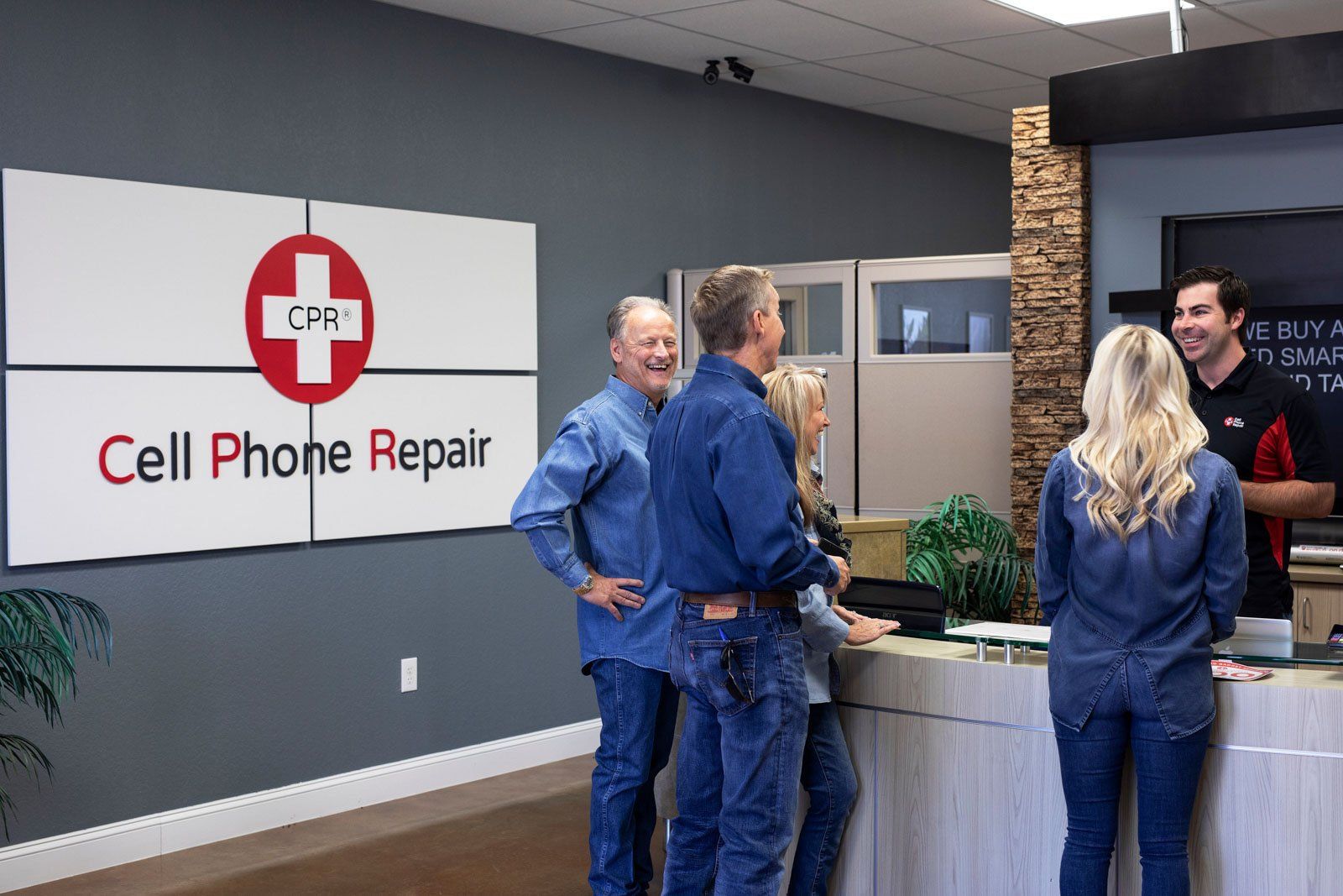 John Reider Properties Team Photo with Cell Phone Property