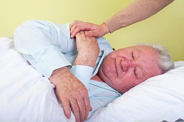 Old man being comforted to sleep