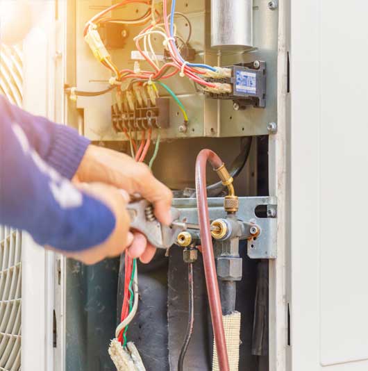 Technician Repairs the AC Unit — Zachary, LA — Hughes Mechanical Contractors Technician Repairs the AC Unit — Zachary, LA — Hughes Mechanical Contractors