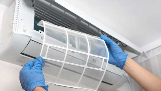 Worker Changing the Air Filter — Zachary, LA — Hughes Mechanical Contractors