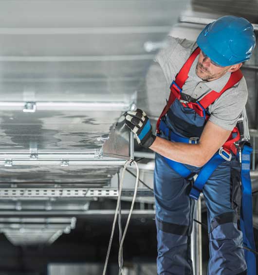 Man Installing Heating and Cooling System — Zachary, LA — Hughes Mechanical Contractors