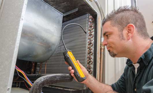 HVAC Technician with Leak Detector — Zachary, LA — Hughes Mechanical Contractors HVAC Technician with Leak Detector — Zachary, LA — Hughes Mechanical Contractors