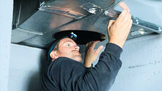 Man Checking the Ventilation — Zachary, LA — Hughes Mechanical Contractors Man Checking the Ventilation — Zachary, LA — Hughes Mechanical Contractors