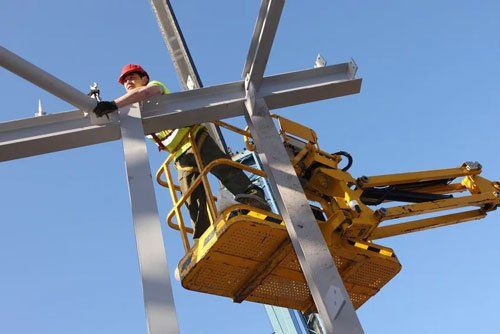 Steel worker on cherry-picker