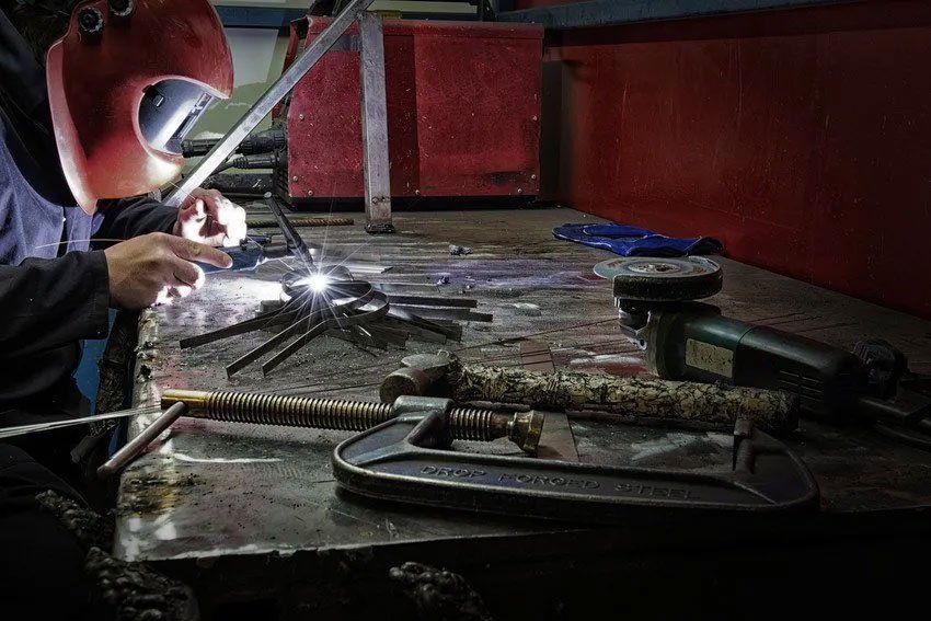 Welder using TIG welding technique to join metal, Note forged steel is not a brand