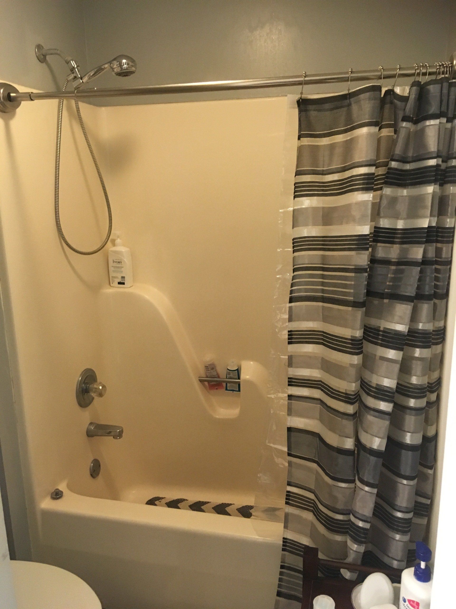A bathroom with a shower , tub , toilet and shower curtain