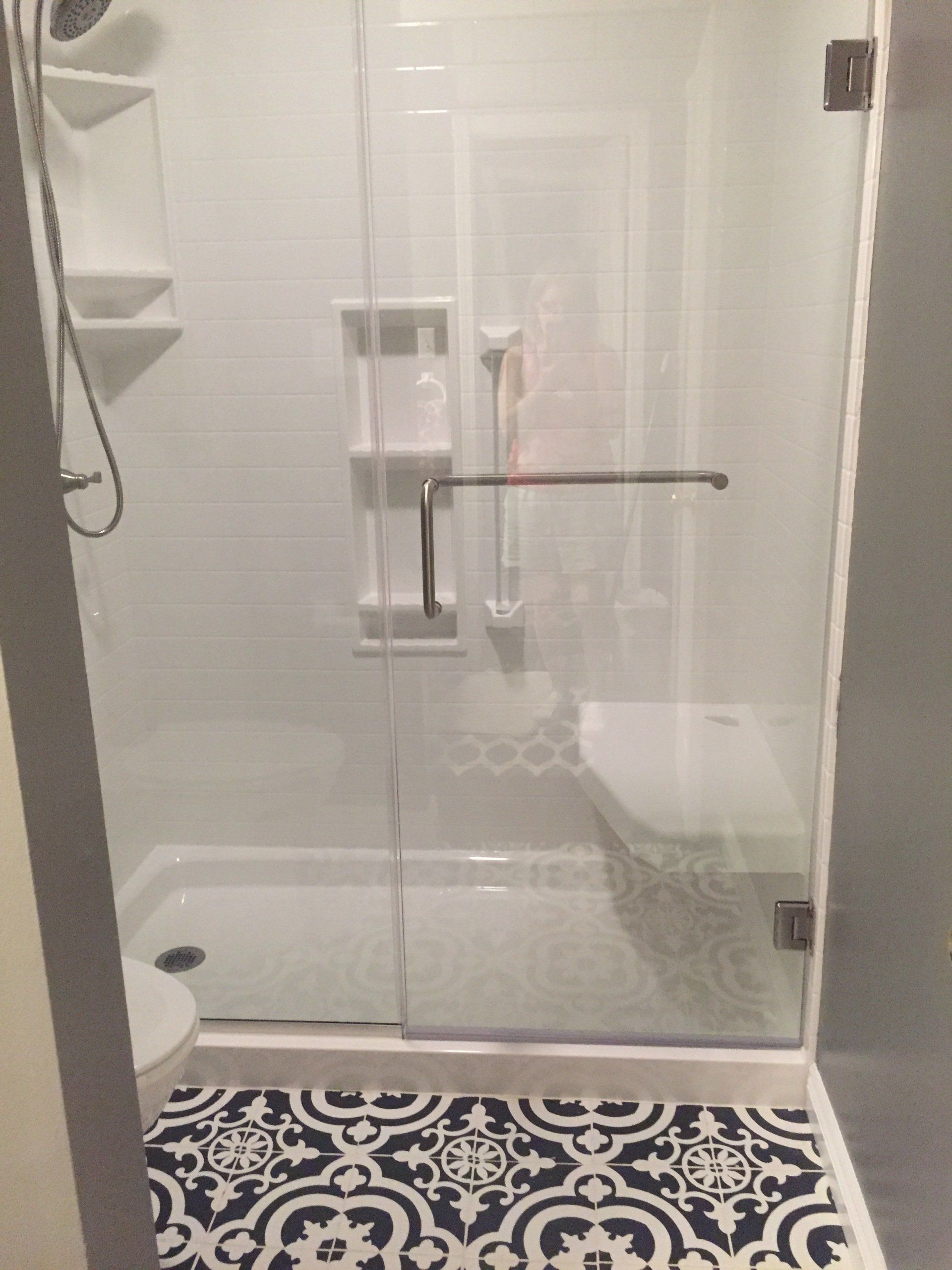 A bathroom with a walk in shower and a toilet.