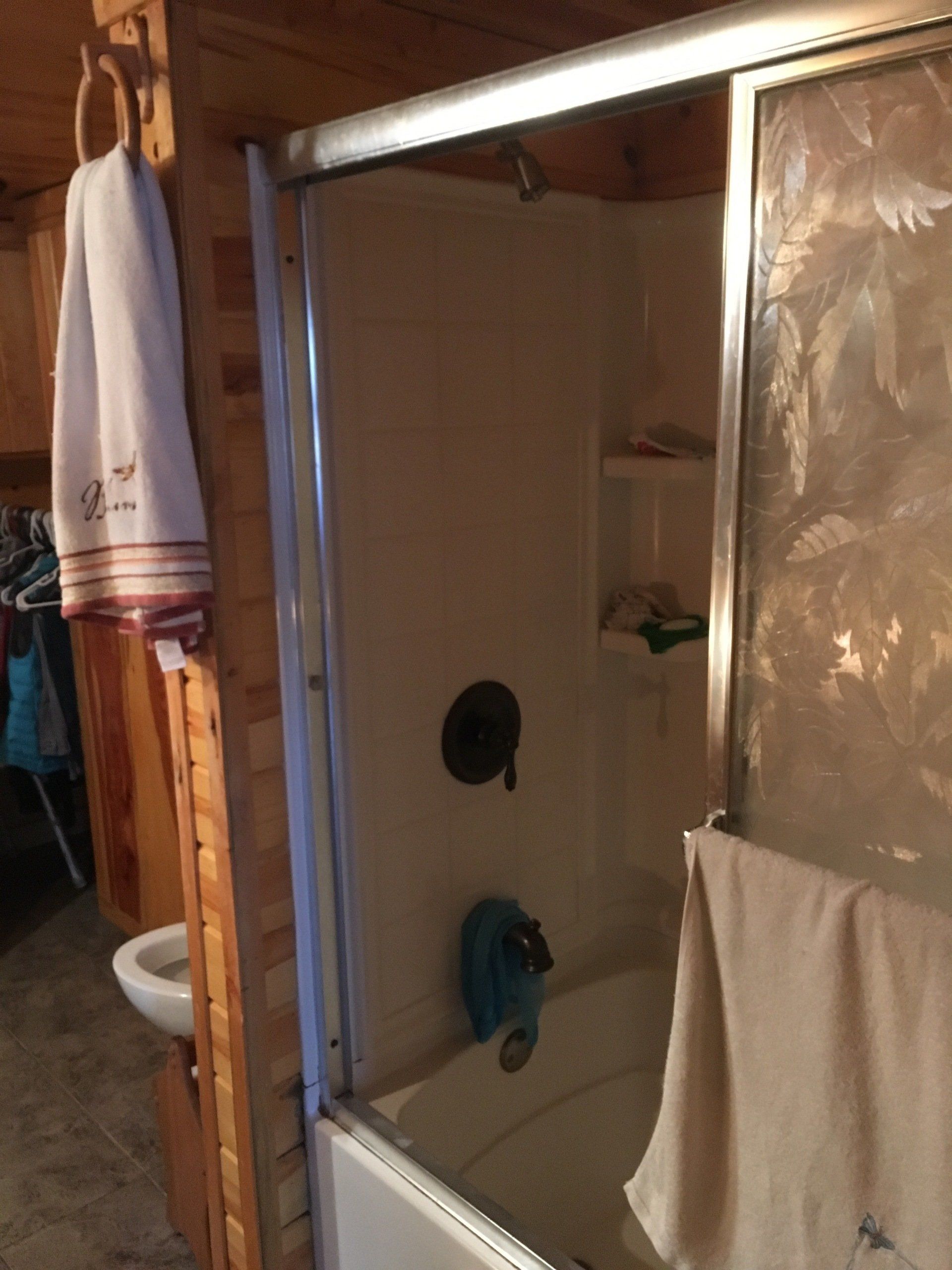 A bathroom with a bathtub and a shower stall