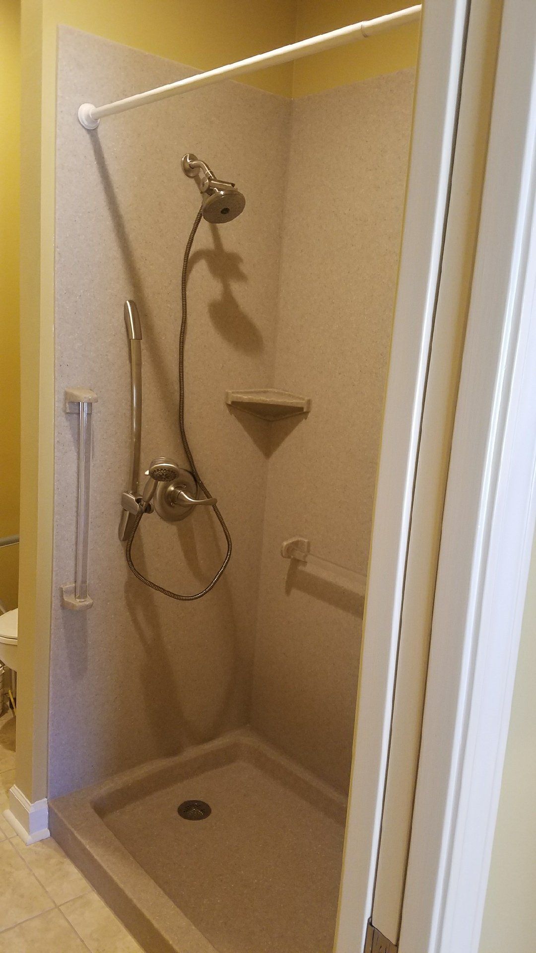 A bathroom with a walk in shower and a toilet.