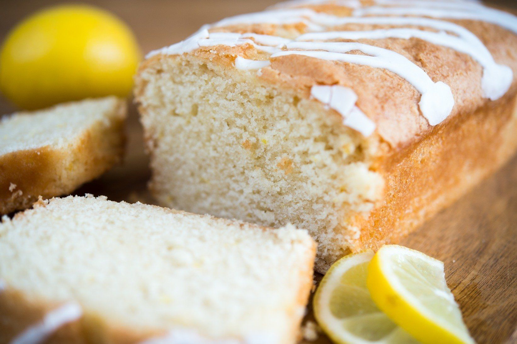 Lemon loaf cake with glaze and lemon slices.