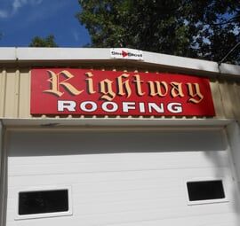 RLH Rightway Roofing & Remodeling Red-and-white Rightway Roofing sign on a building exterior with garage doors beneath it