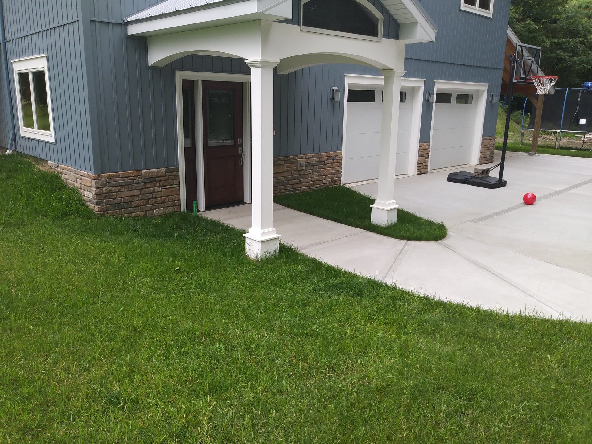 front of blue house without landscaping