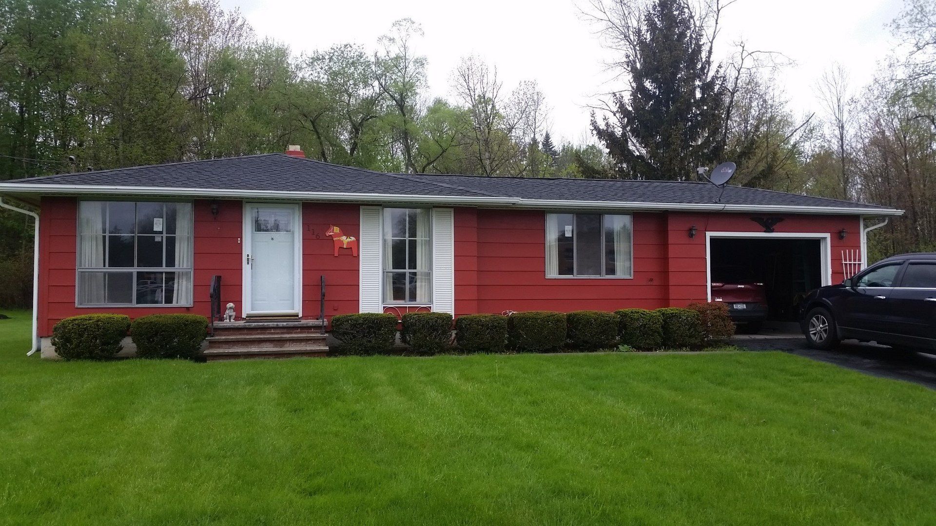 shrubs in front of red house