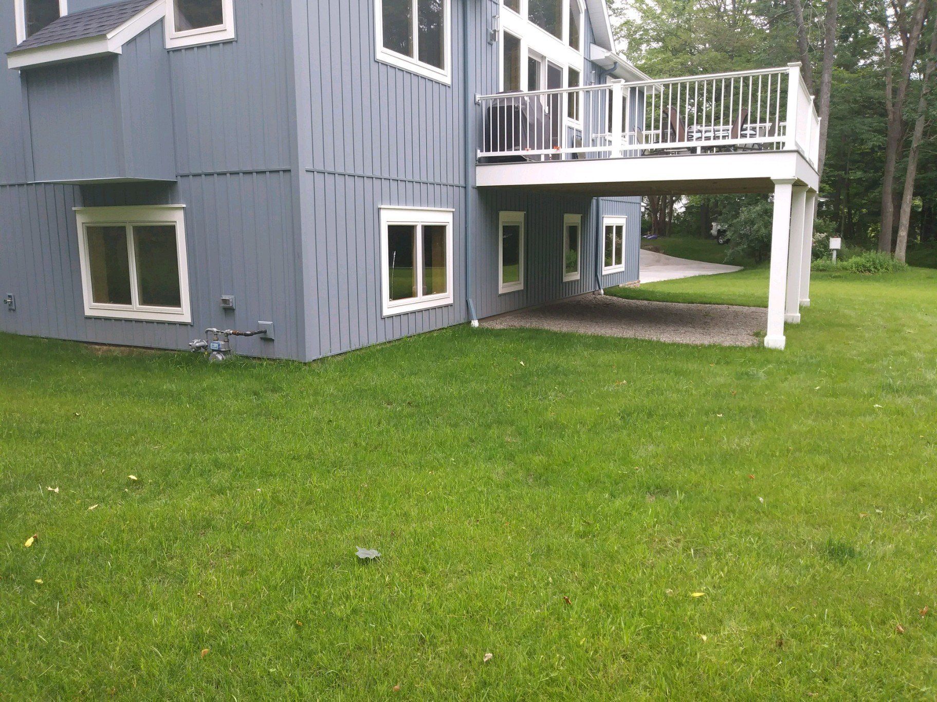 back of blue house without landscaping