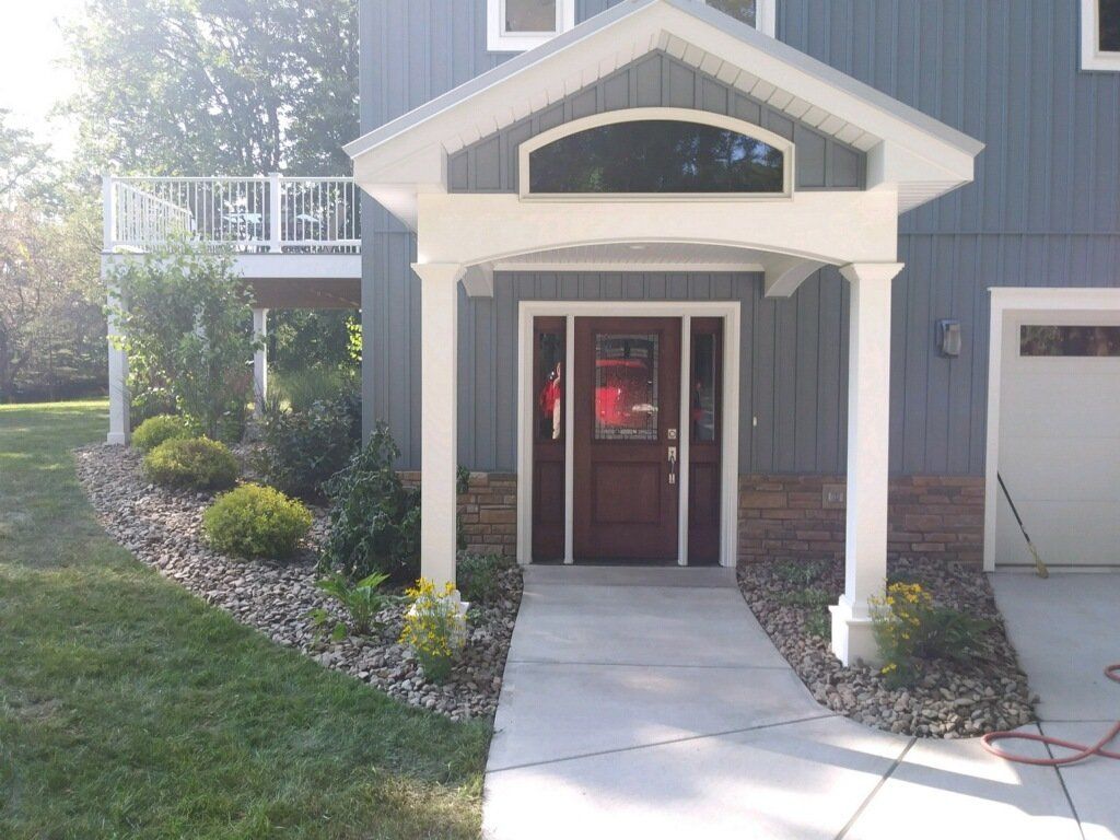 front of blue house with landscaping services
