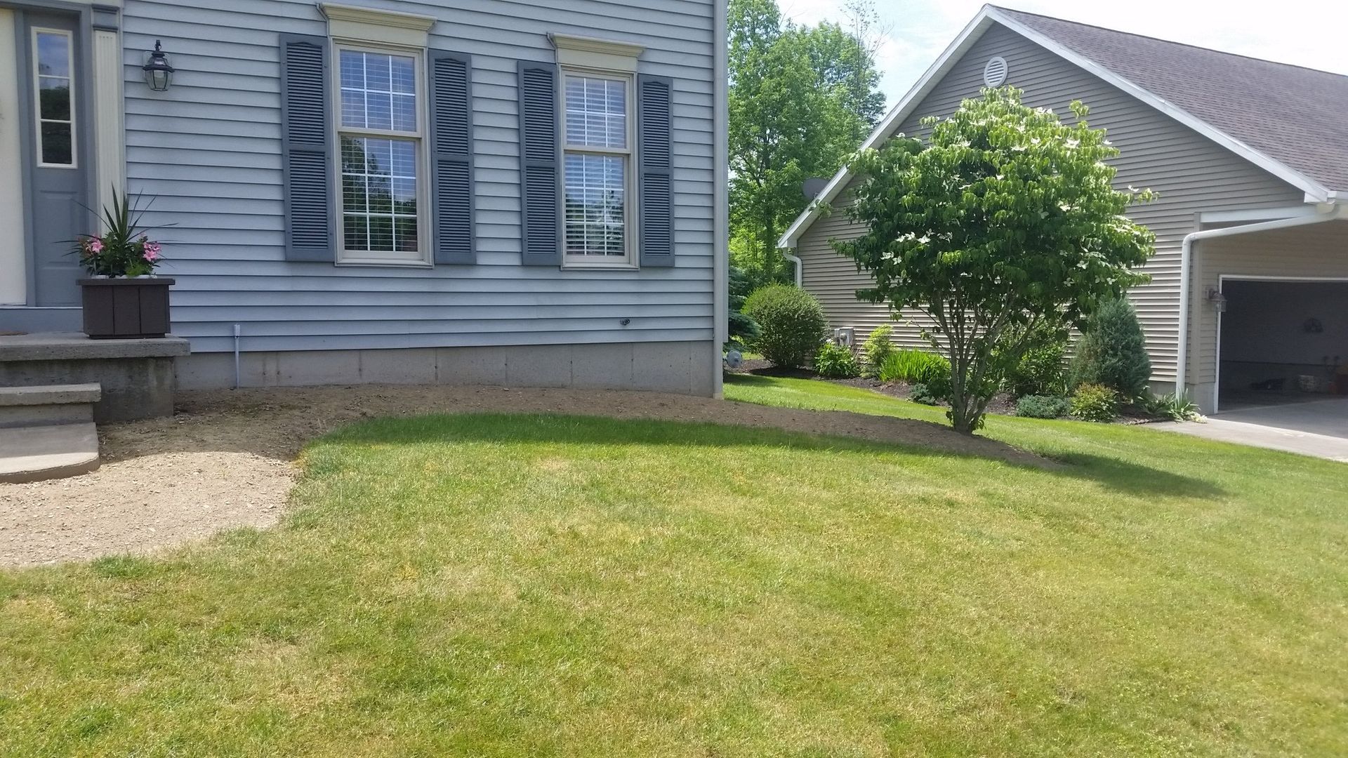 front right side of blue house without landscaping