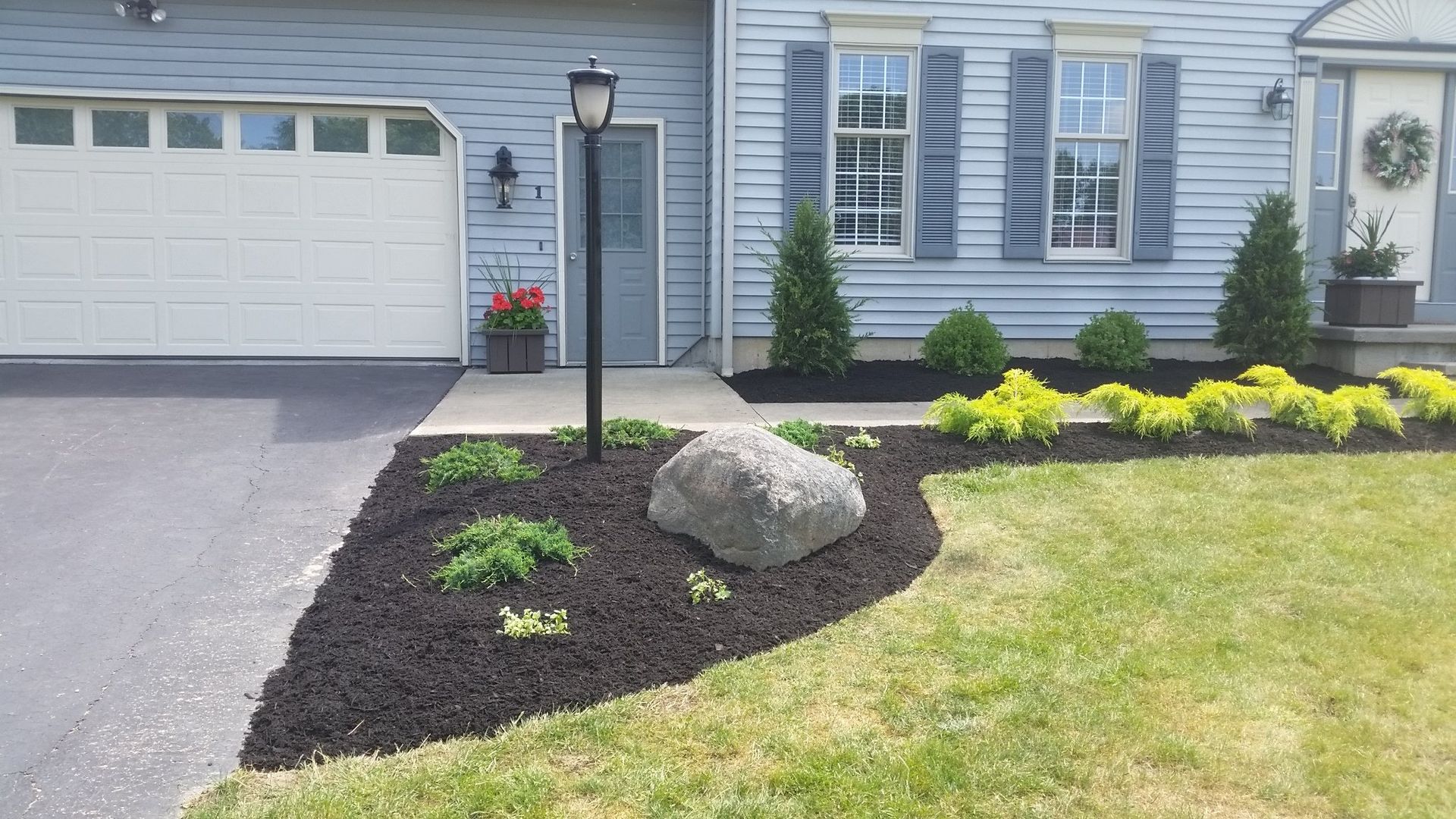 street light and flowerbed in front of house