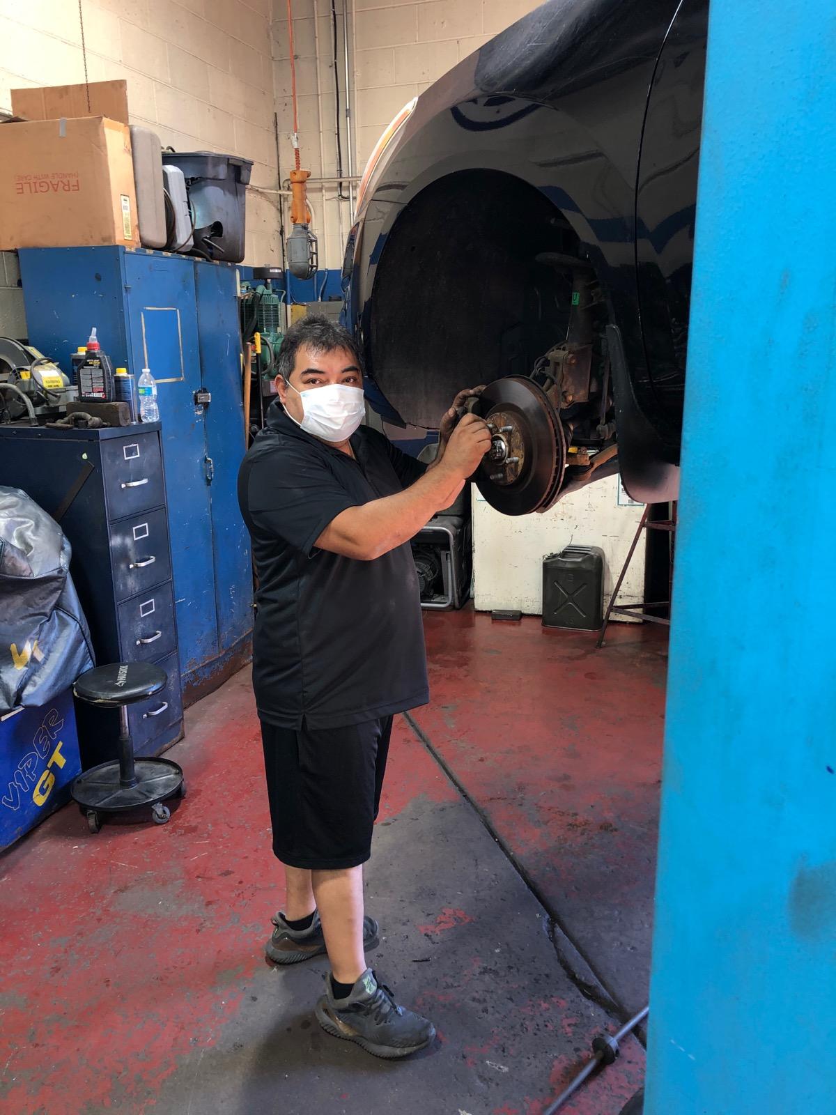Brake Repair — Mechanic Wearing Face Mask Repairing Car in Chicago, IL