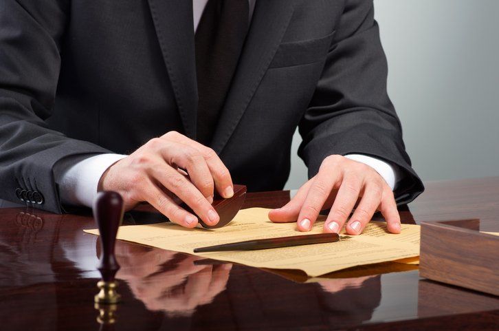 Lawyer stamping the documents — Will & Trust in Augusta, ME Lawyer stamping the documents — Will & Trust in Augusta, ME