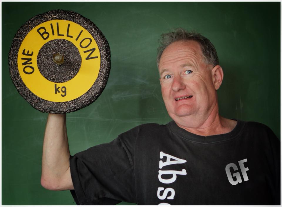 A man is holding up a barbell that says one billion kg