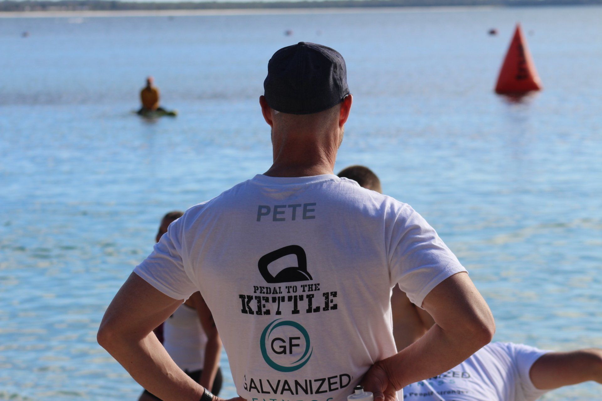 A man wearing a white shirt with the name pete on it