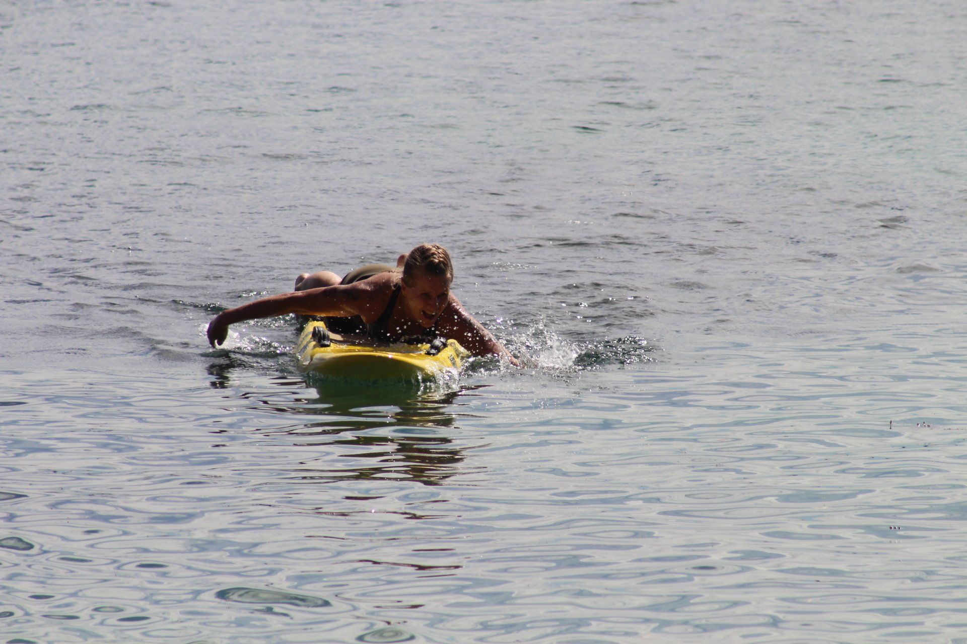 A man is riding a surfboard in the water.
