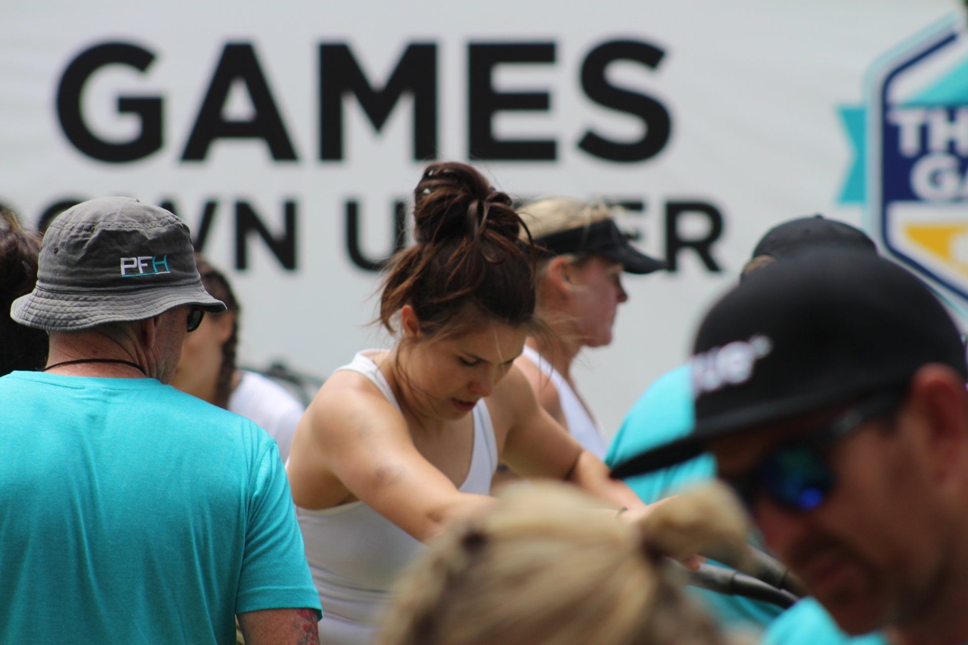 A group of people are standing in front of a sign that says games