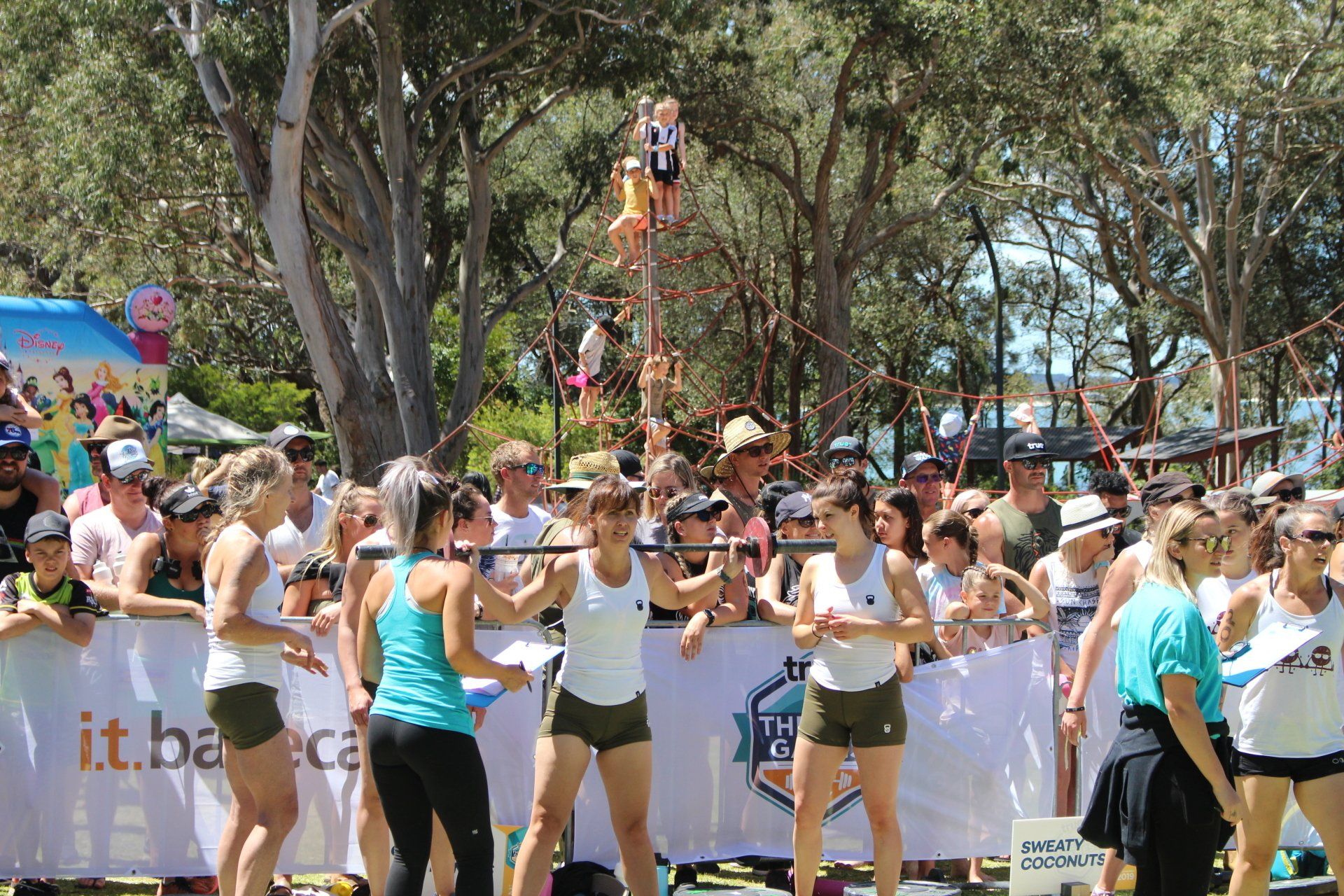 A group of women are dancing in front of a crowd of people.