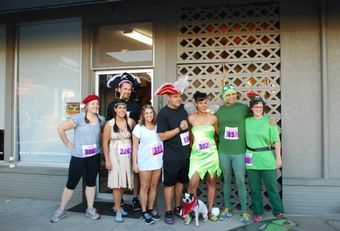 A group of people in costumes are posing for a picture