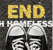 A pair of black and white sneakers with the words `` end homelessness '' written on them.