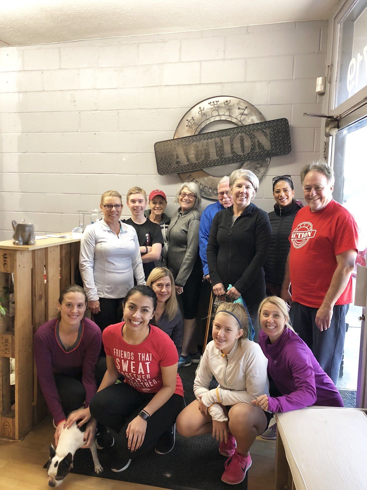 A group of women are posing for a picture in a gym.
