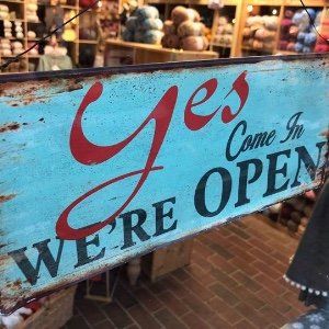 A sign that says yes come in we 're open